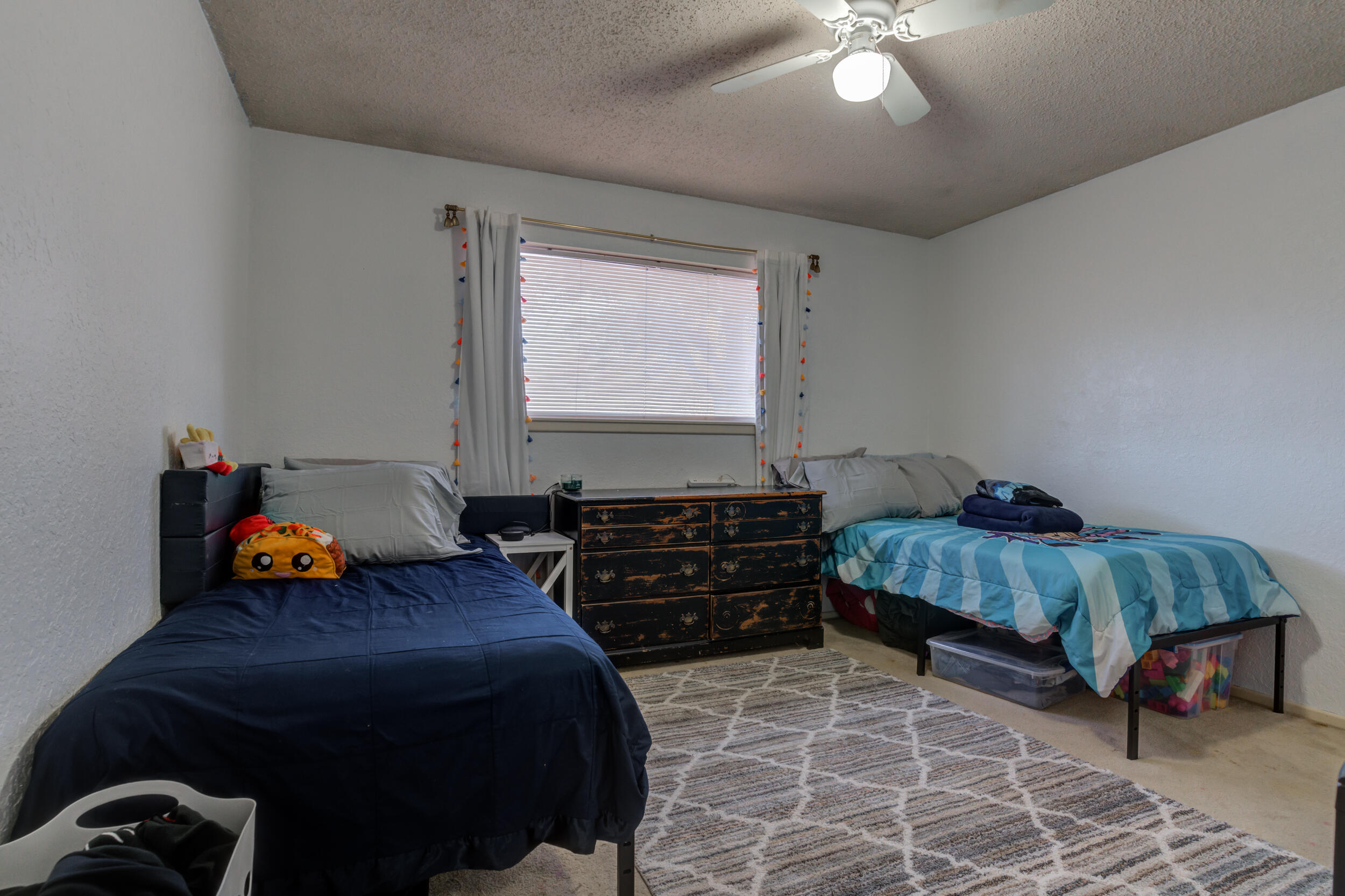 4524 79th Street Lubbock, TX 79424 - Photo 39 of 45 a bedroom with furniture and a chandelier