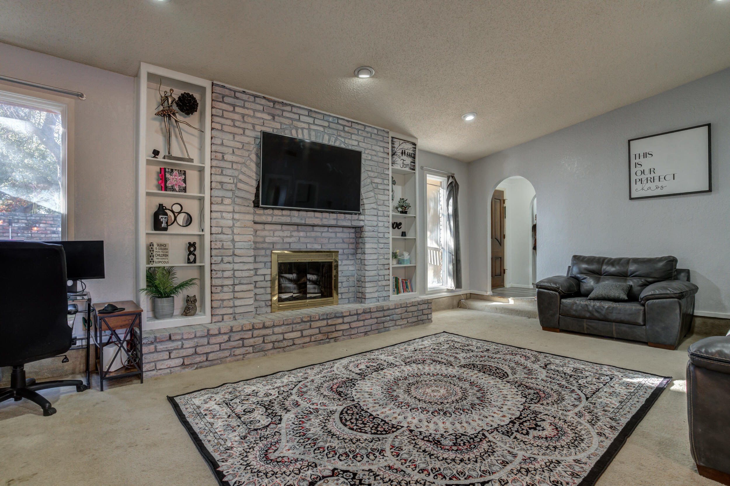 4524 79th Street Lubbock, TX 79424 - Photo 9 of 45 a living room with furniture and a fireplace