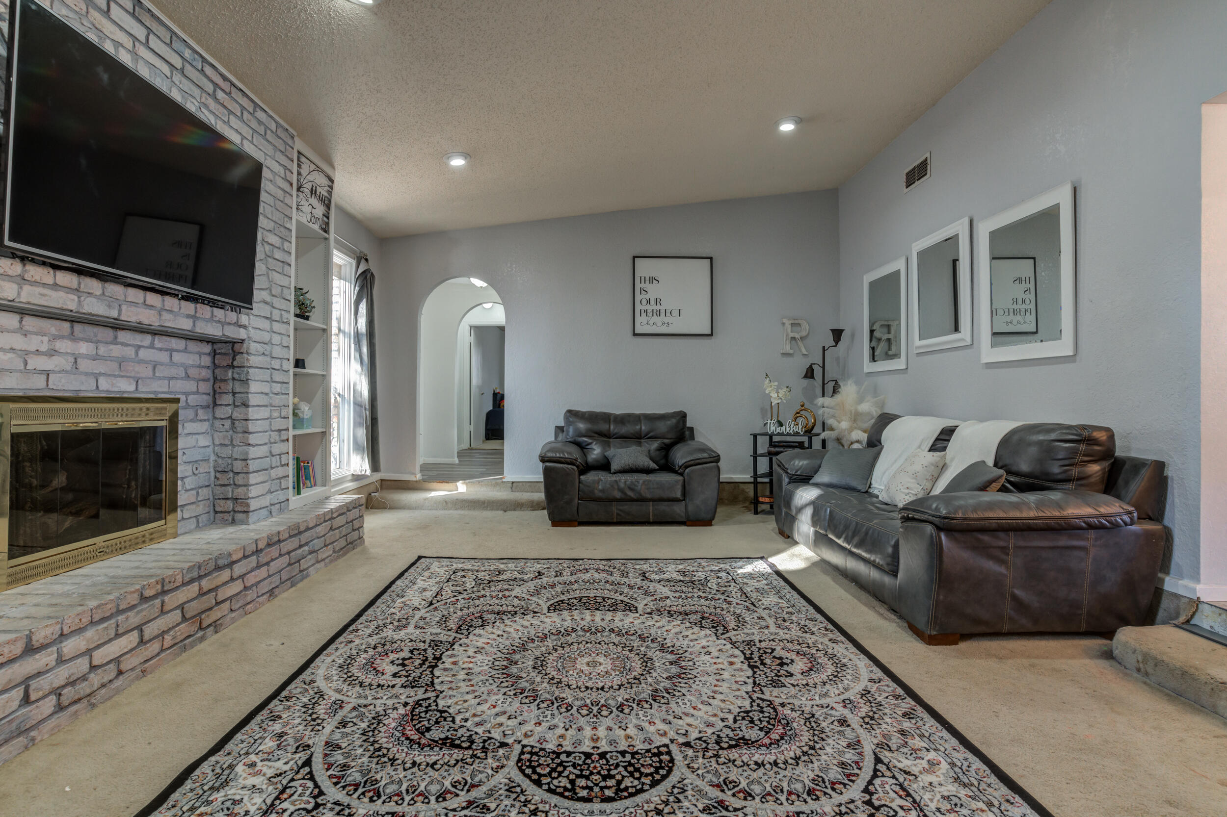 4524 79th Street Lubbock, TX 79424 - Photo 10 of 45 a living room with furniture and a fireplace