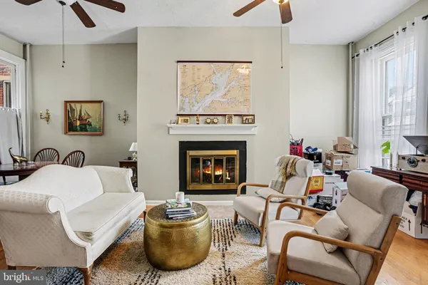 a living room with furniture a fireplace and a chandelier