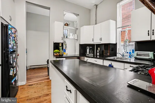 a kitchen with stainless steel appliances granite countertop a sink a stove and a microwave