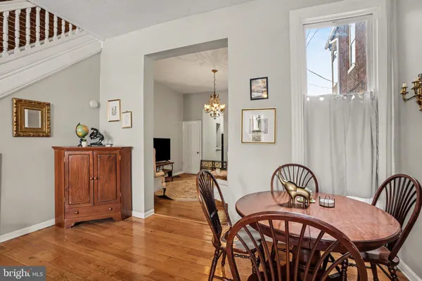 a dining room with furniture and wooden floor
