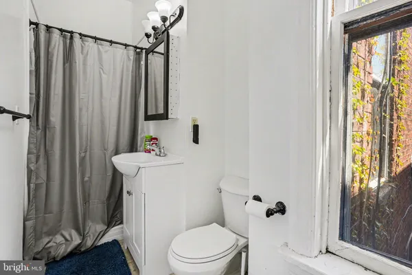 a white toilet sitting next to a bathroom sink