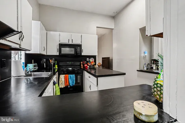 a kitchen with a sink and a stove top oven