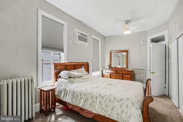 a bedroom with bed and a table