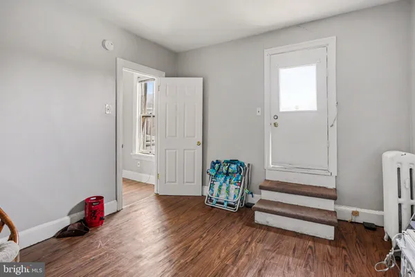 an empty room with wooden floor and a window