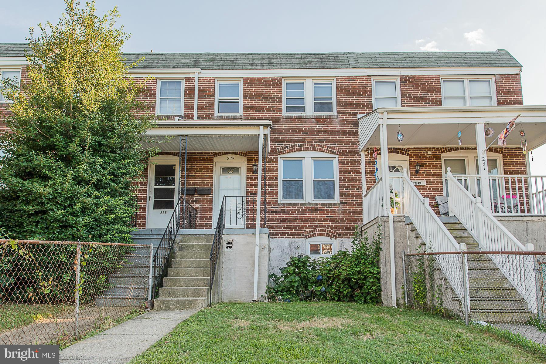 229 West Edgevale Road Baltimore, MD 21225 - Photo 1 of 13 front view of a house with a yard