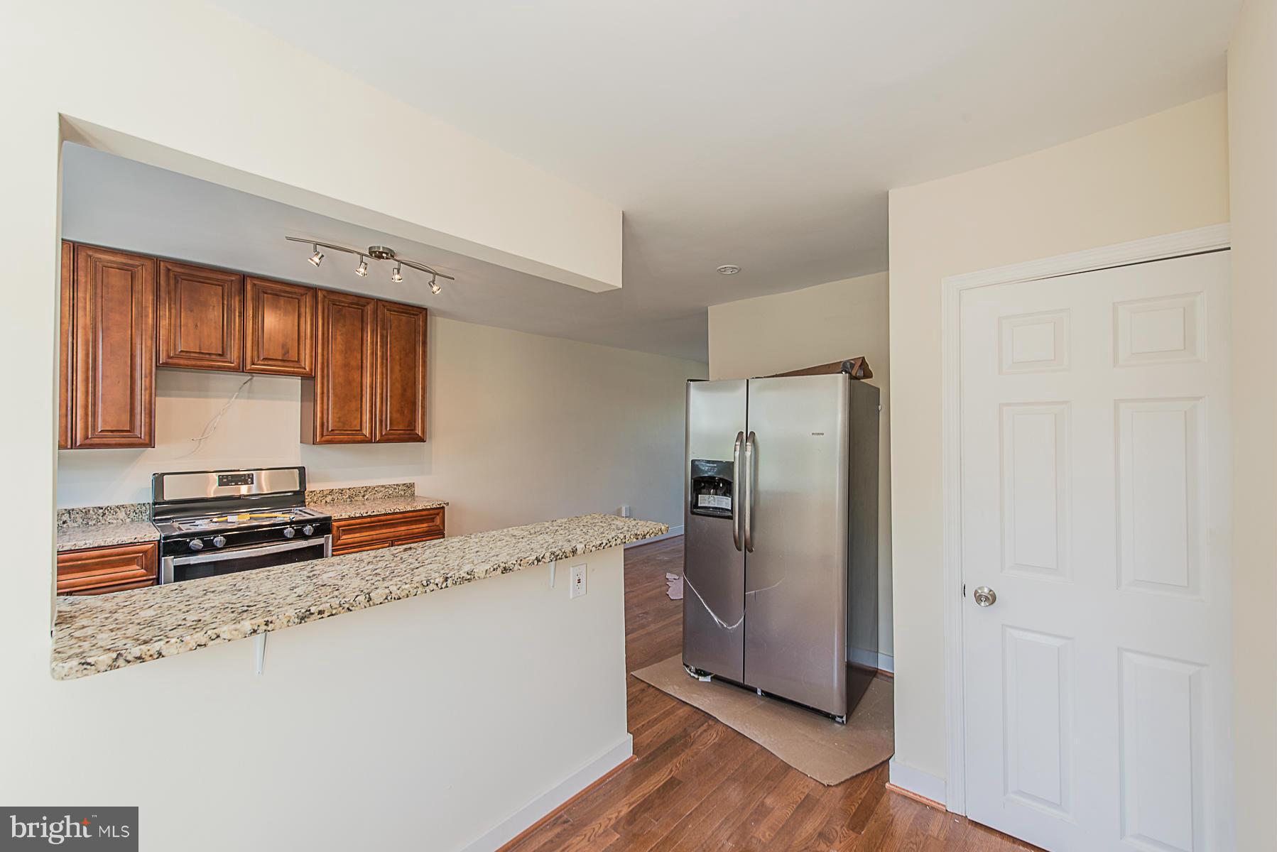 229 West Edgevale Road Baltimore, MD 21225 - Photo 6 of 13 a kitchen with stainless steel appliances a refrigerator stove and sink