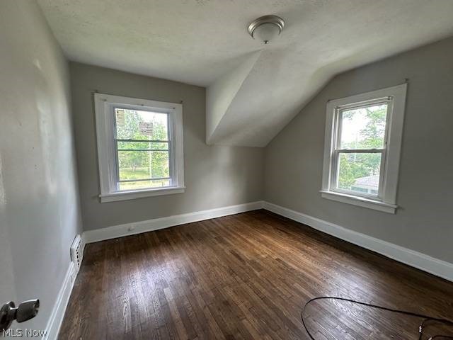 1752 South Taylor Road Cleveland, OH 44118 - Photo 7 of 14 Additional living space with a healthy amount of sunlight, dark hardwood / wood-style flooring, and vaulted ceiling
