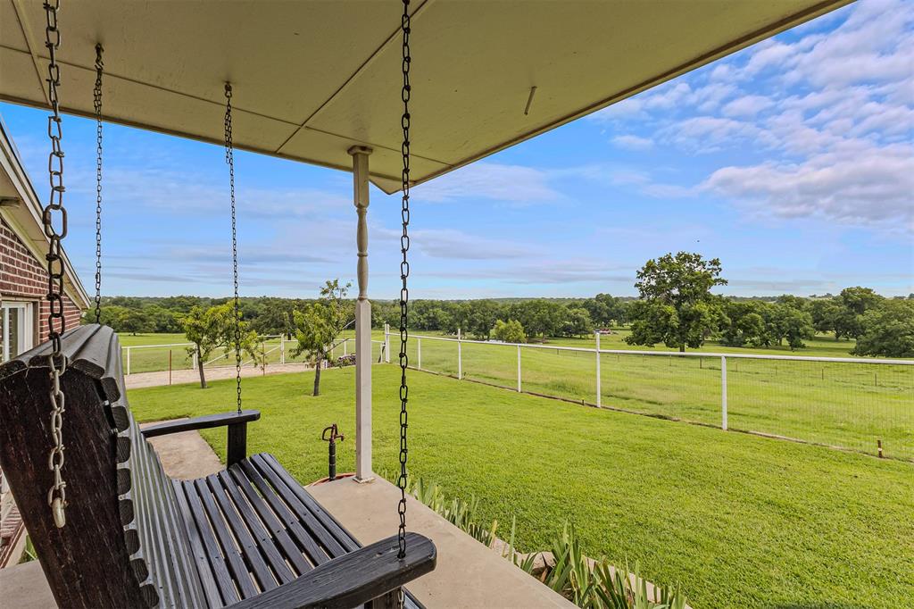 339 Colwell Road Forestburg, TX 76239 - Photo 4 of 31 Porch swing to enjoy those beautiful Texas skies of 339 Colwell Rd in Forestburg, TX