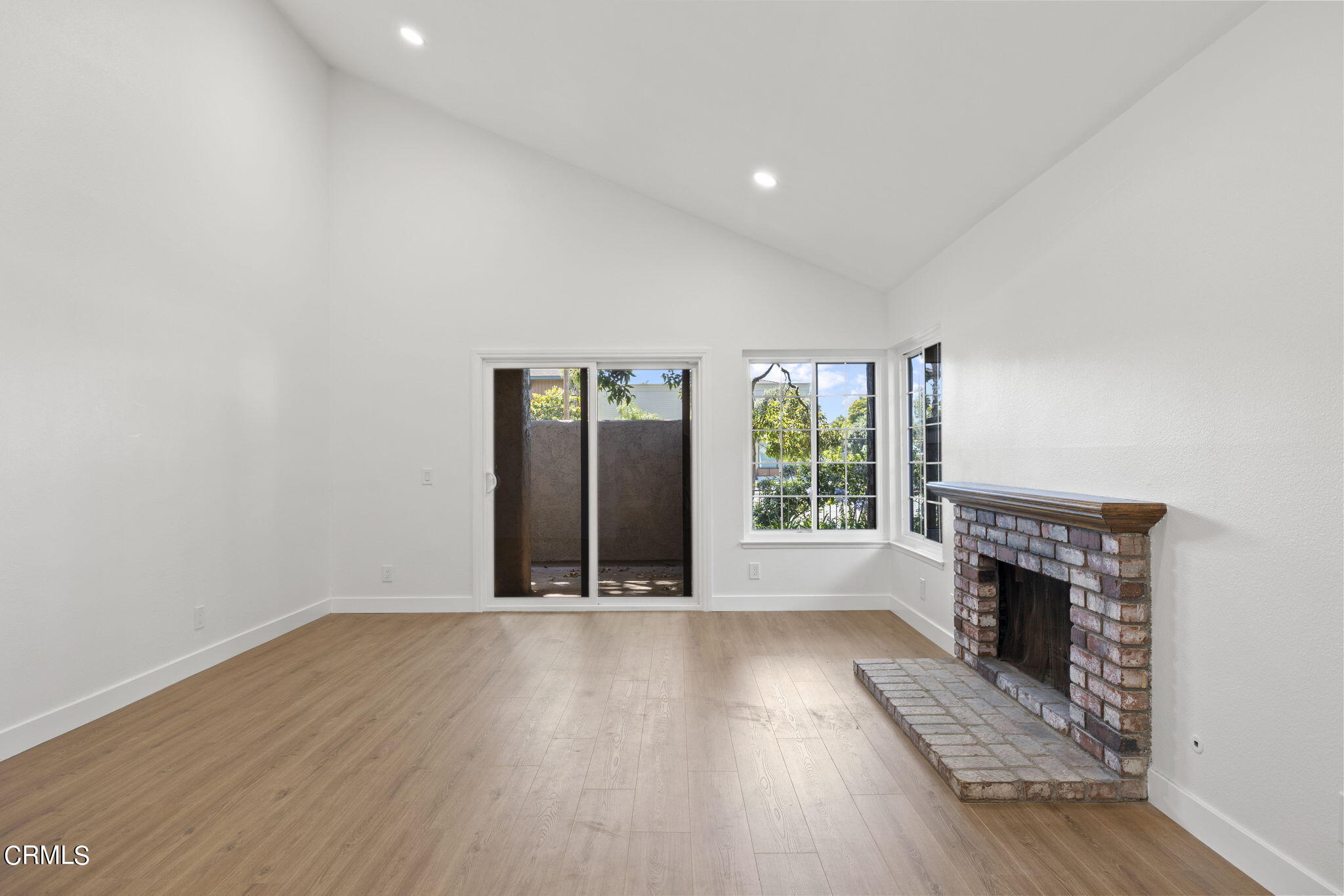 3764 Via Pacifica Walk Oxnard, CA 93035 - Photo 15 of 44 an empty room with wooden floor and fireplace