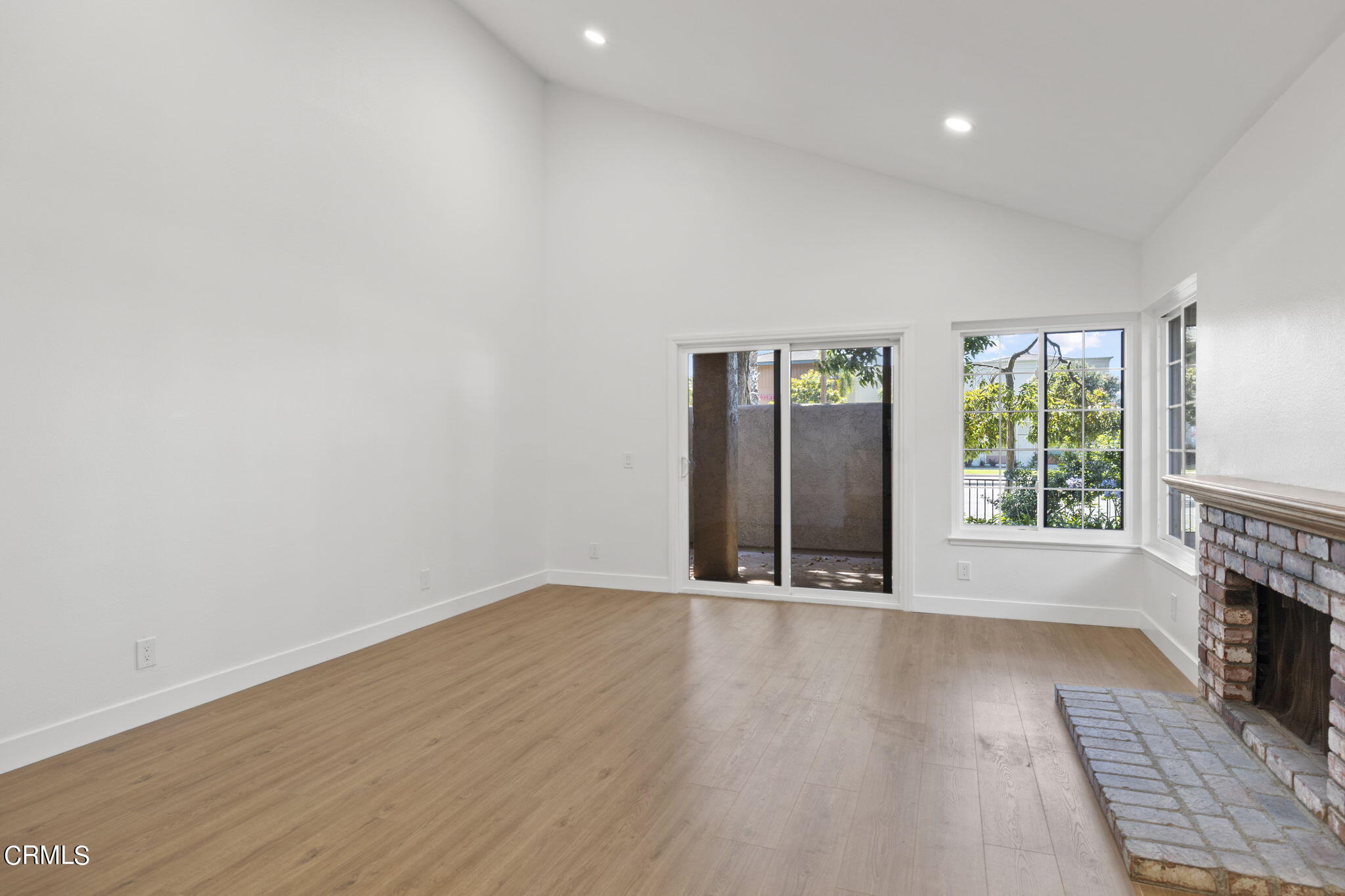 3764 Via Pacifica Walk Oxnard, CA 93035 - Photo 16 of 44 an empty room with wooden floor and windows