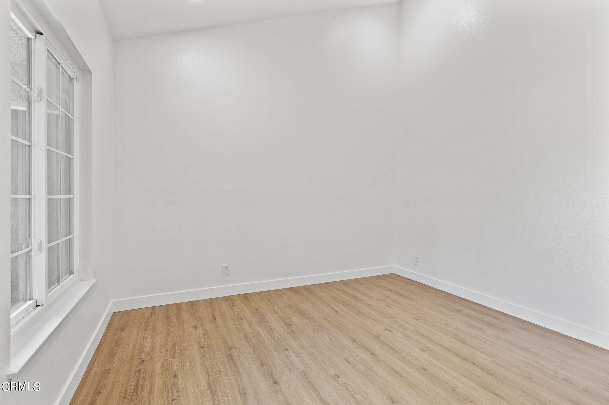 3764 Via Pacifica Walk Oxnard, CA 93035 - Photo 30 of 44 a view of an empty room with wooden floor and a window