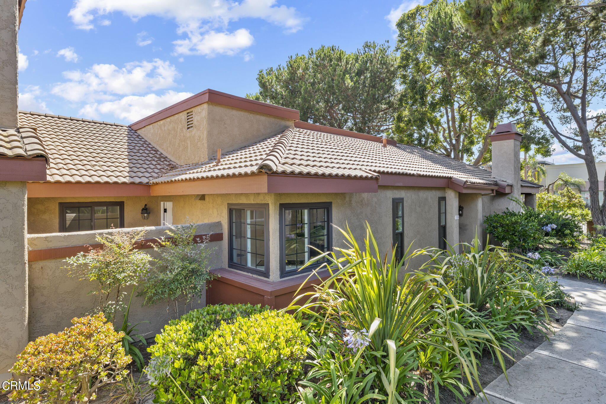 3764 Via Pacifica Walk Oxnard, CA 93035 - Photo 3 of 44 a front view of a house with a garden