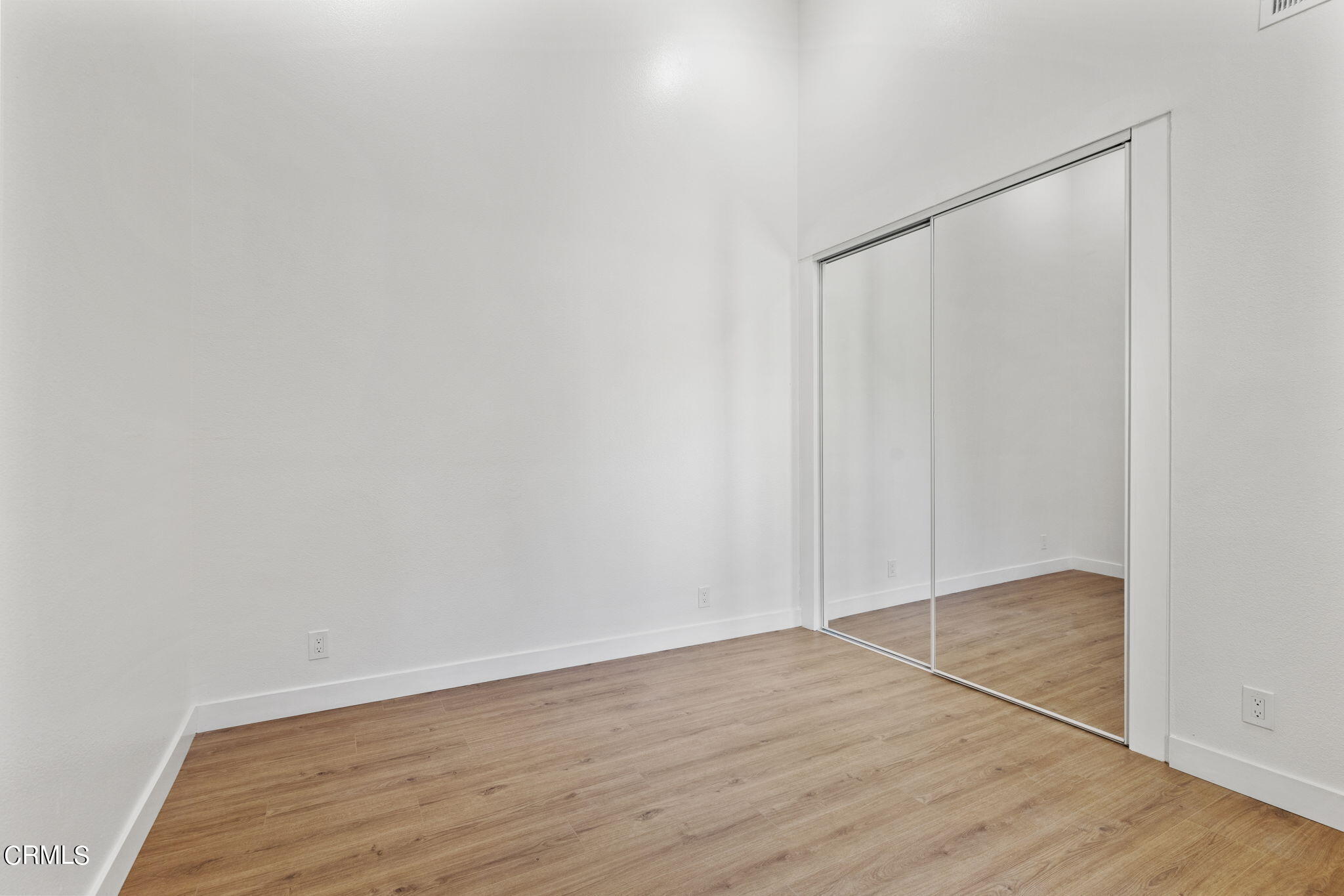 3764 Via Pacifica Walk Oxnard, CA 93035 - Photo 31 of 44 a view of an empty room with wooden floor