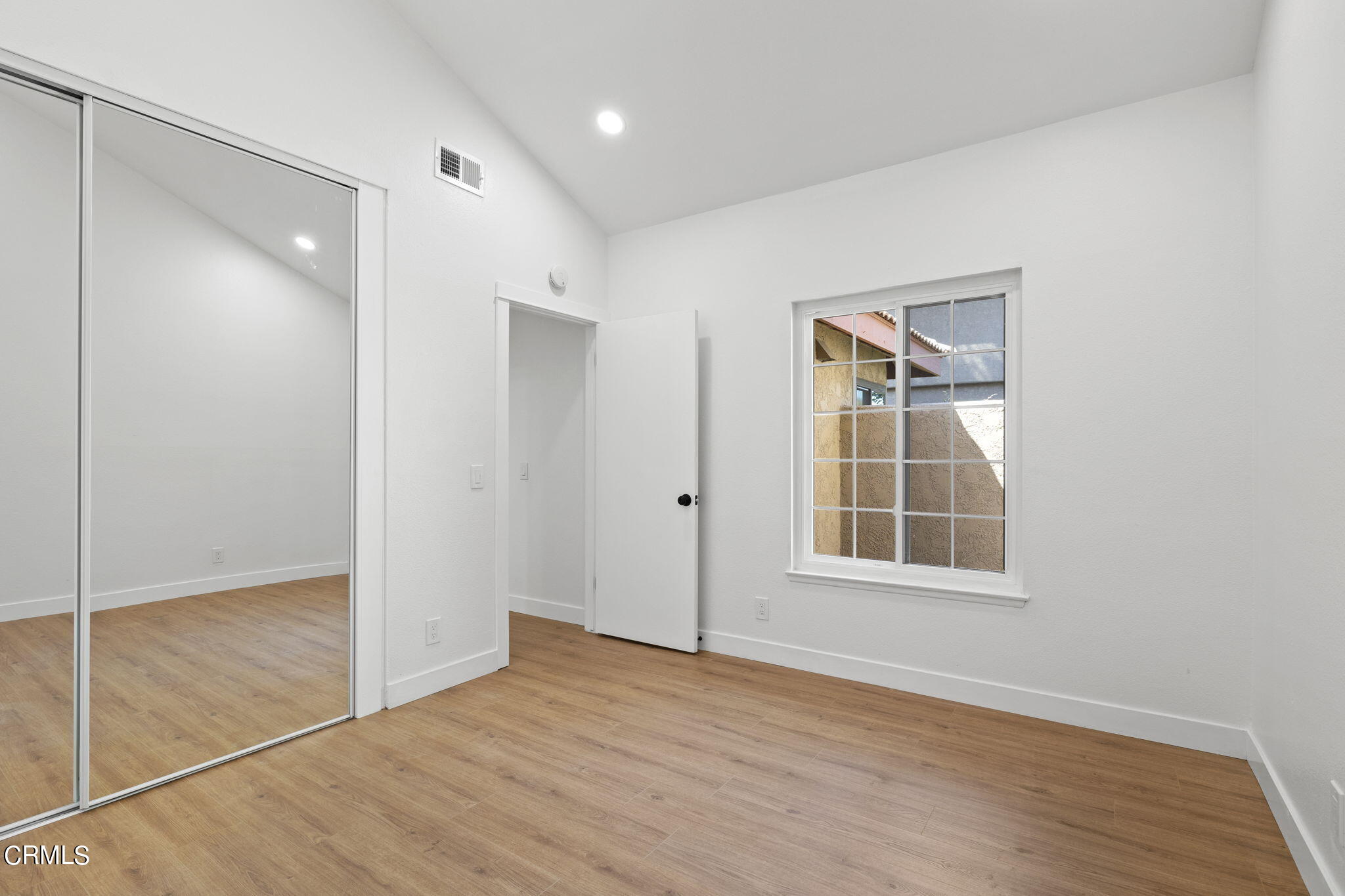 3764 Via Pacifica Walk Oxnard, CA 93035 - Photo 32 of 44 an empty room with wooden floor and windows