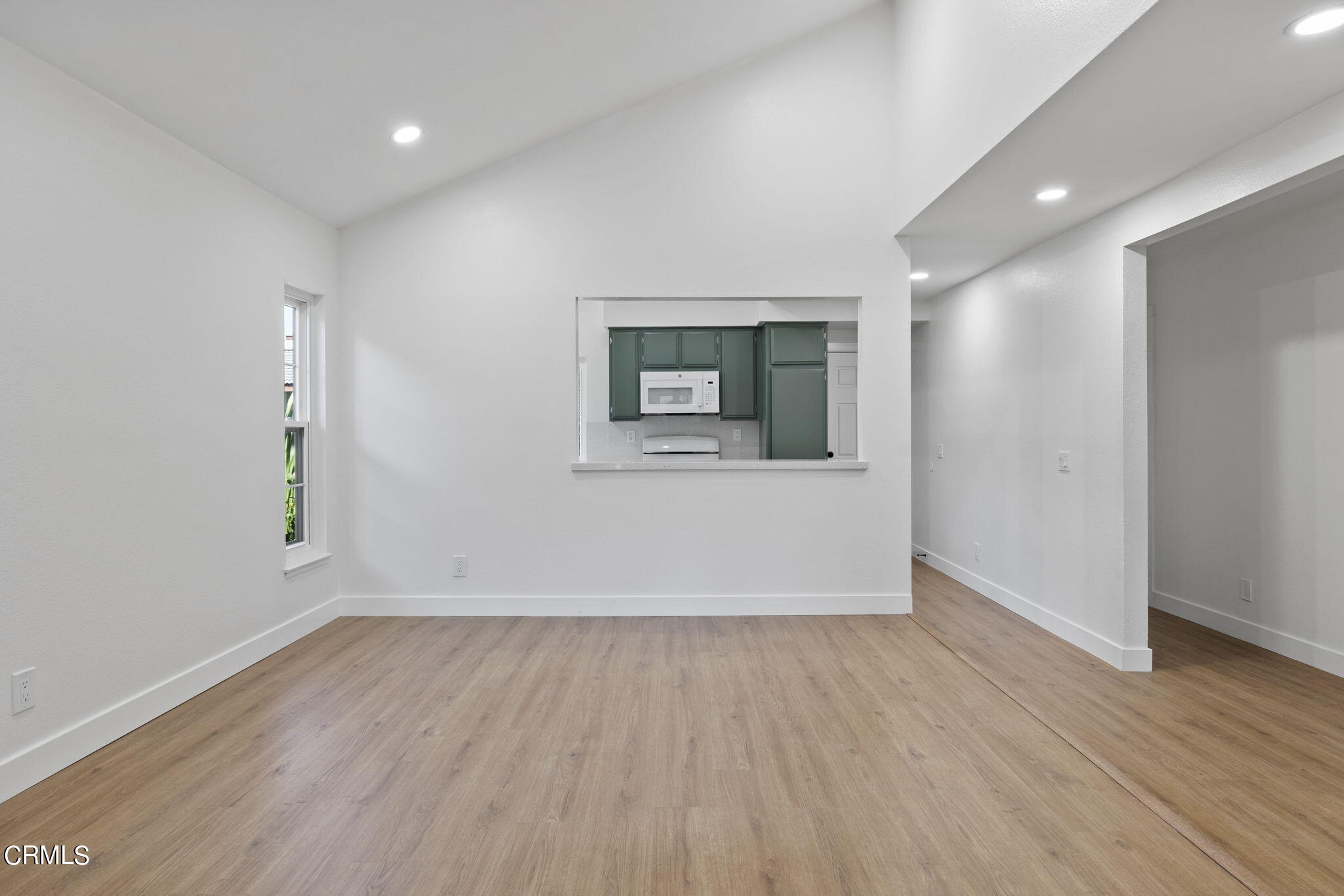 3764 Via Pacifica Walk Oxnard, CA 93035 - Photo 6 of 44 an empty room with wooden floor and windows