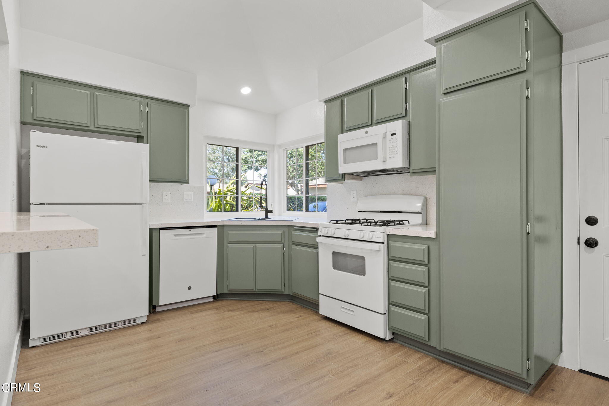 3764 Via Pacifica Walk Oxnard, CA 93035 - Photo 9 of 44 a kitchen with white cabinets and white appliances