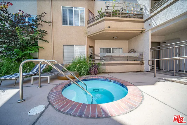 a view of a house with swimming pool and furniture