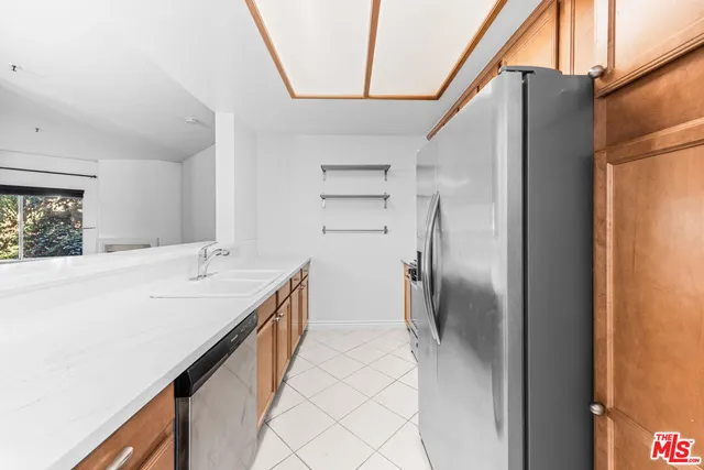 a kitchen with stainless steel appliances a refrigerator and a sink