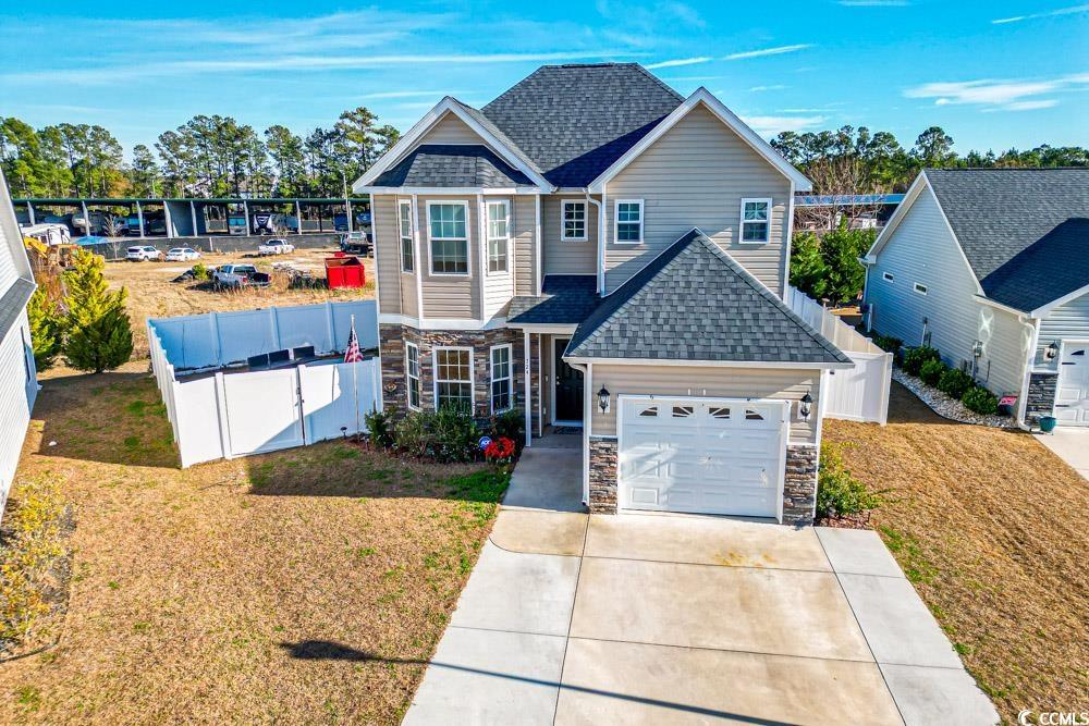 724 Hobonny Loop Longs, SC 29568 - Photo 40 of 40 View of front of property with stone siding, a shingled roof, driveway, and a gate