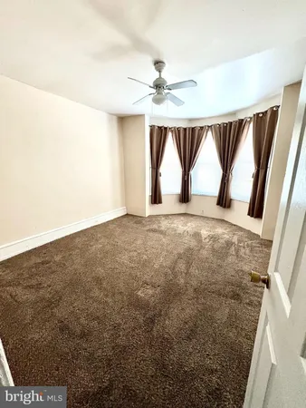 a view of empty room with ceiling fan