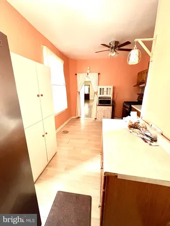 a living room with a sink furniture and a wooden floor