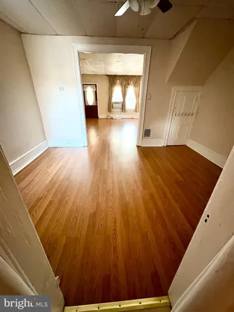 a view of a room with wooden floor