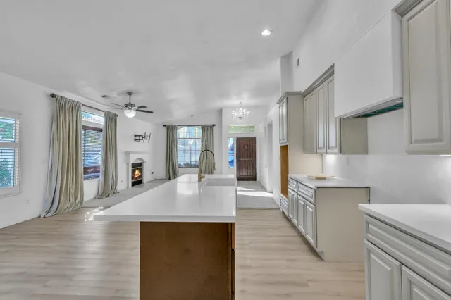 a large kitchen with stainless steel appliances granite countertop a lot of counter space and wooden floors