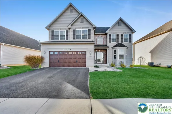 a front view of a house with a yard and garage