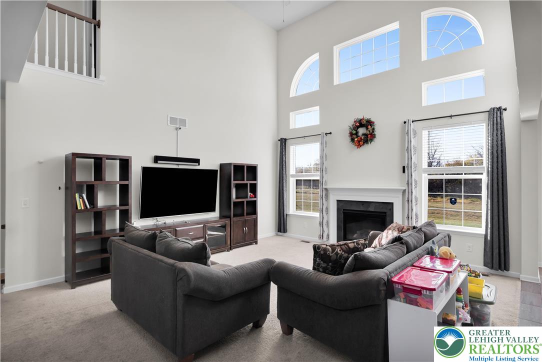 4247 Beech Drive Nazareth, PA 18064 - Photo 13 of 42 a living room with furniture a flat screen tv and a fireplace