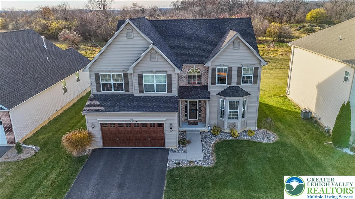 4247 Beech Drive Nazareth, PA 18064 - Photo 2 of 42 a front view of a house with a garden