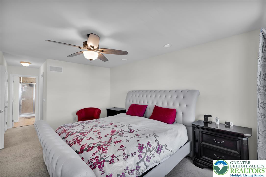 4247 Beech Drive Nazareth, PA 18064 - Photo 24 of 42 a bedroom with a bed and a chandelier