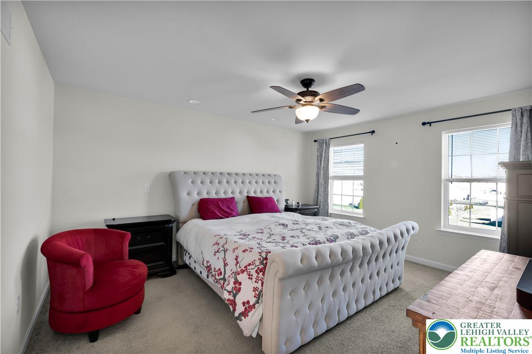 4247 Beech Drive Nazareth, PA 18064 - Photo 25 of 42 a bedroom with a bed and a chandelier