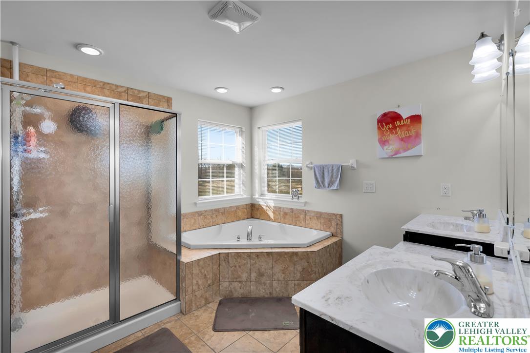 4247 Beech Drive Nazareth, PA 18064 - Photo 26 of 42 a bathroom with a tub sink and mirror