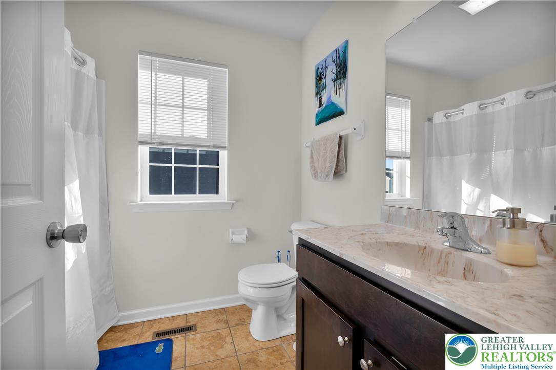 4247 Beech Drive Nazareth, PA 18064 - Photo 30 of 42 a bathroom with a granite countertop sink a toilet and a window