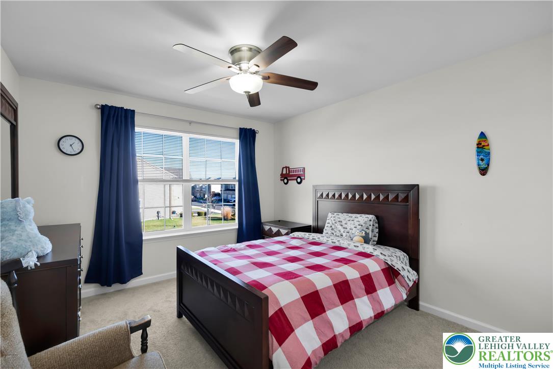 4247 Beech Drive Nazareth, PA 18064 - Photo 31 of 42 a spacious bedroom with a large bed and a chandelier