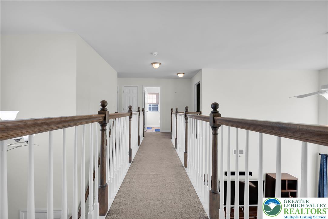 4247 Beech Drive Nazareth, PA 18064 - Photo 34 of 42 a view of a hallway with wooden floor and stairs