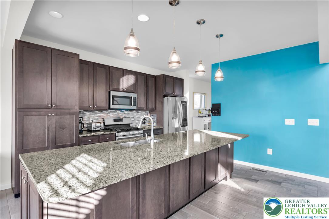 4247 Beech Drive Nazareth, PA 18064 - Photo 10 of 42 a kitchen with stainless steel appliances granite countertop a sink stove and refrigerator