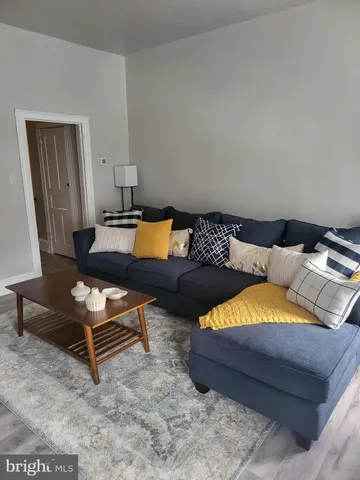a bed sitting in a bedroom and wooden floor