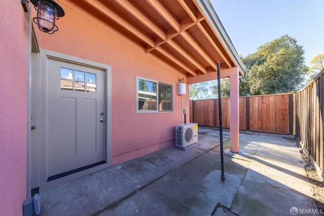 a backyard of a house with table and chairs