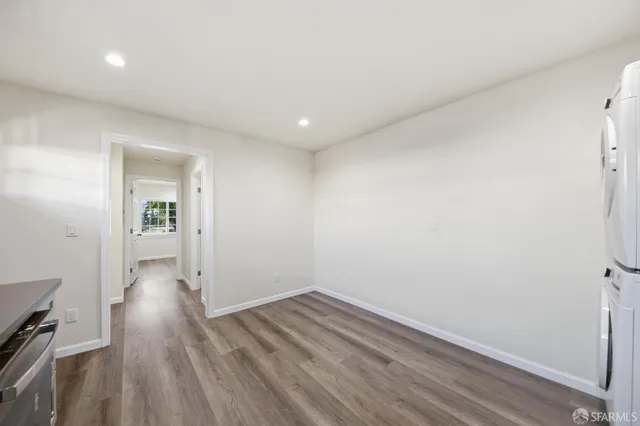 a view of wooden floor and windows in a room