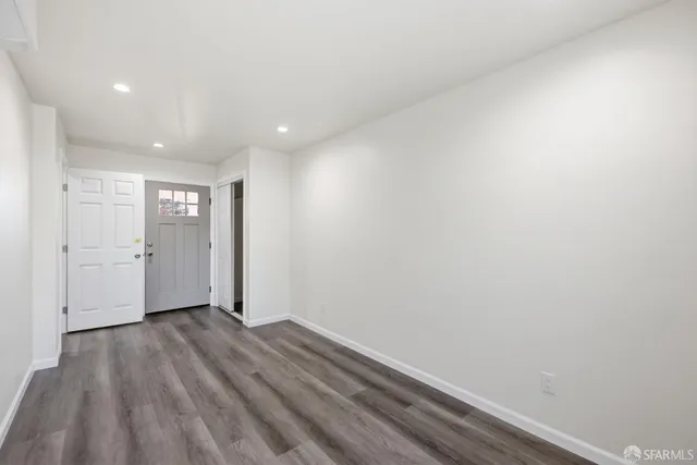 a view of hallway with wooden floor