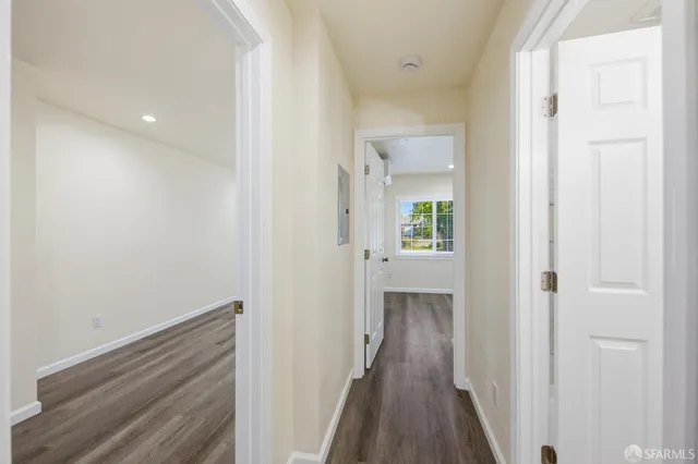 a view of a hallway with wooden floor