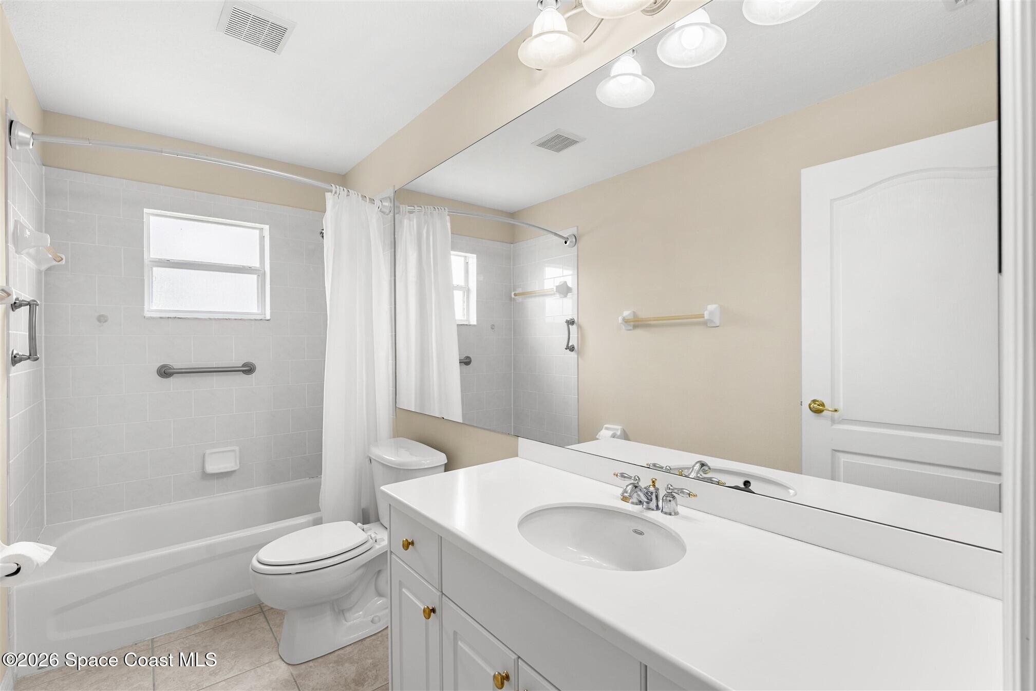 6904 Renshaw Drive Melbourne, FL 32940 - Photo 26 of 46 a bathroom with a granite countertop sink a toilet and shower