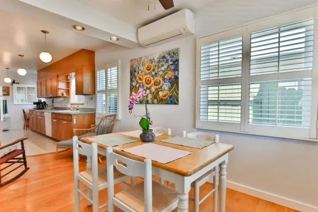 a kitchen with a stove a kitchen island a table and chairs