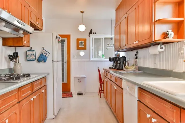 a kitchen with stainless steel appliances a sink a stove and a refrigerator