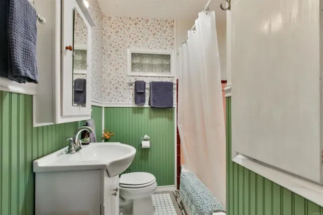 a bathroom with a sink toilet and mirror