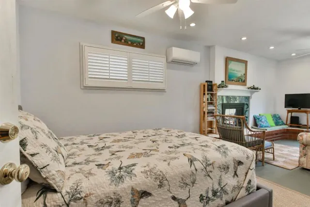 a bedroom with a bed and a television