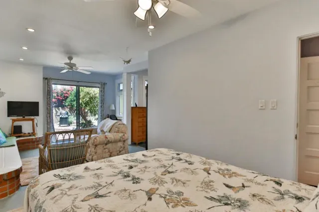 a bedroom with a bed window and a flat screen tv